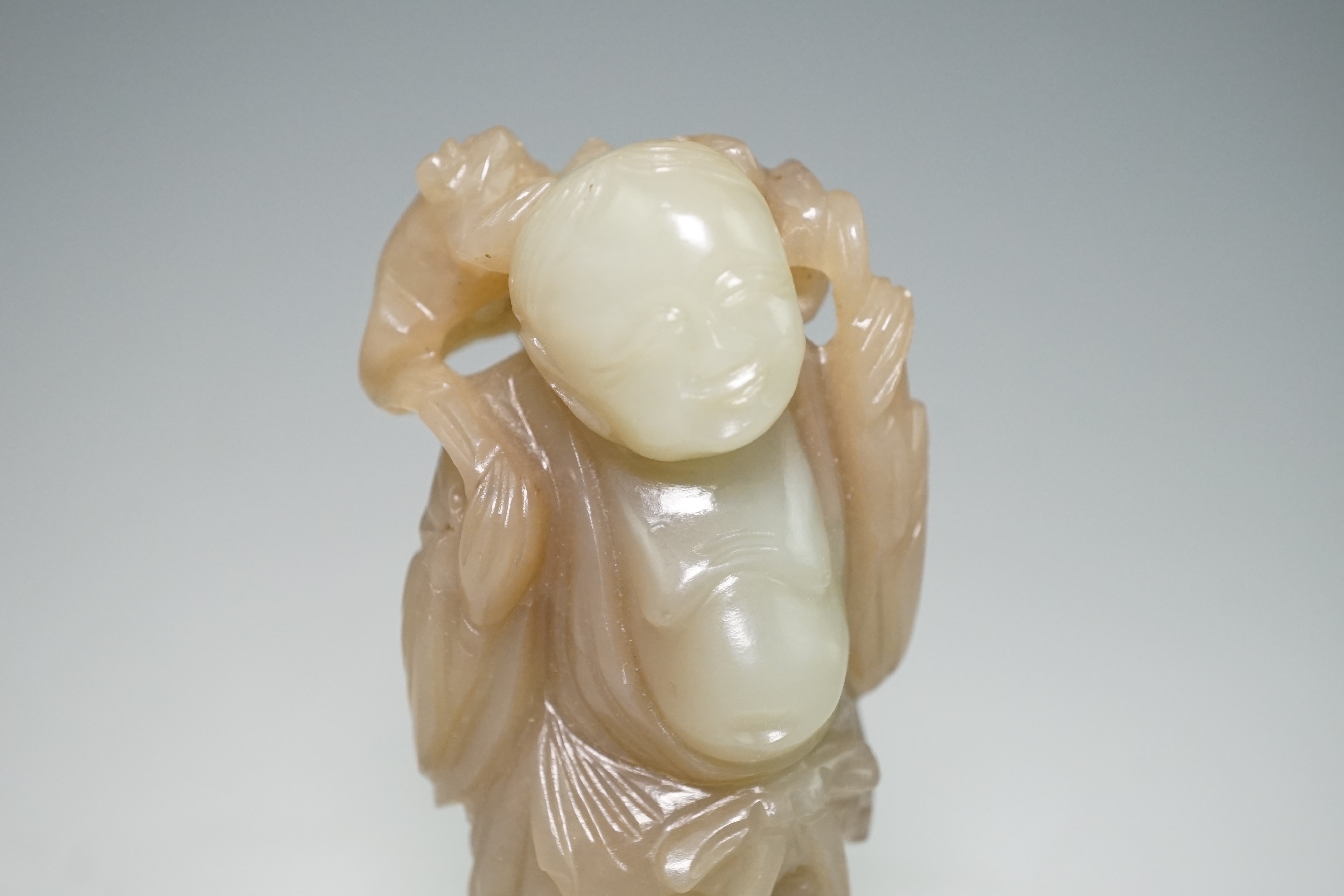 A Chinese pale celadon and brown jade group of Liu Hai and his three legged toad, Qianlong period (1736-95)